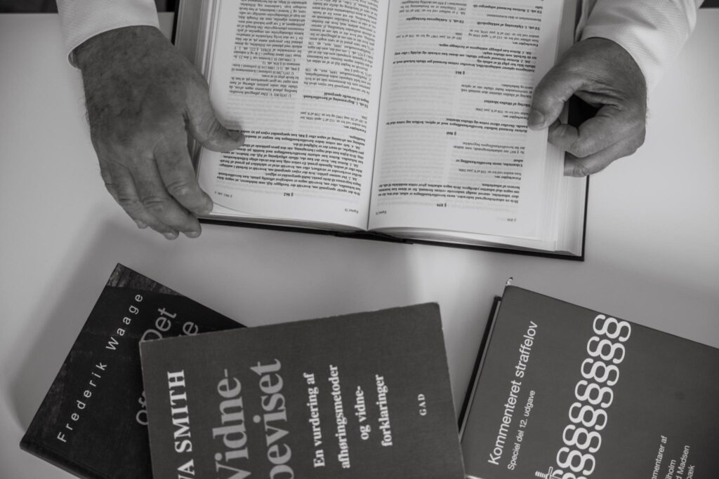 Billede af advokat der er i gang med at slå op i en bog